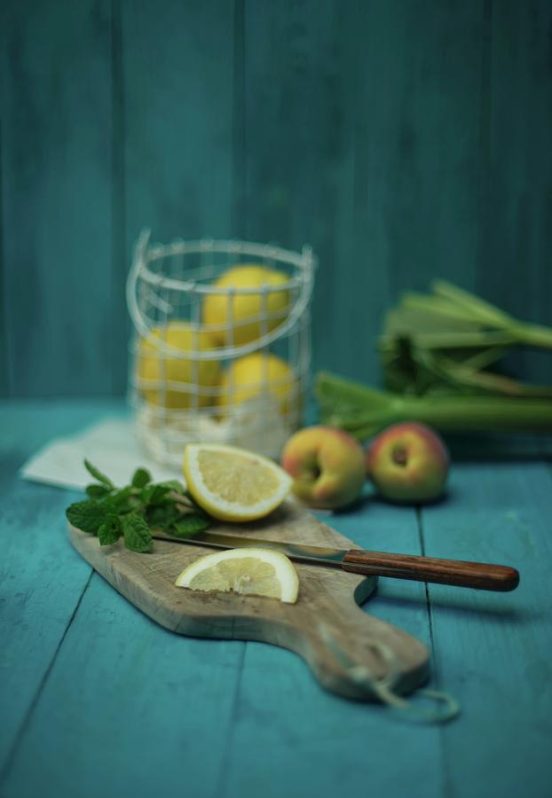 An Arrangement Of Lemons, Peaches, Mint And Rhubarb Photograph by Angelika Grossmann