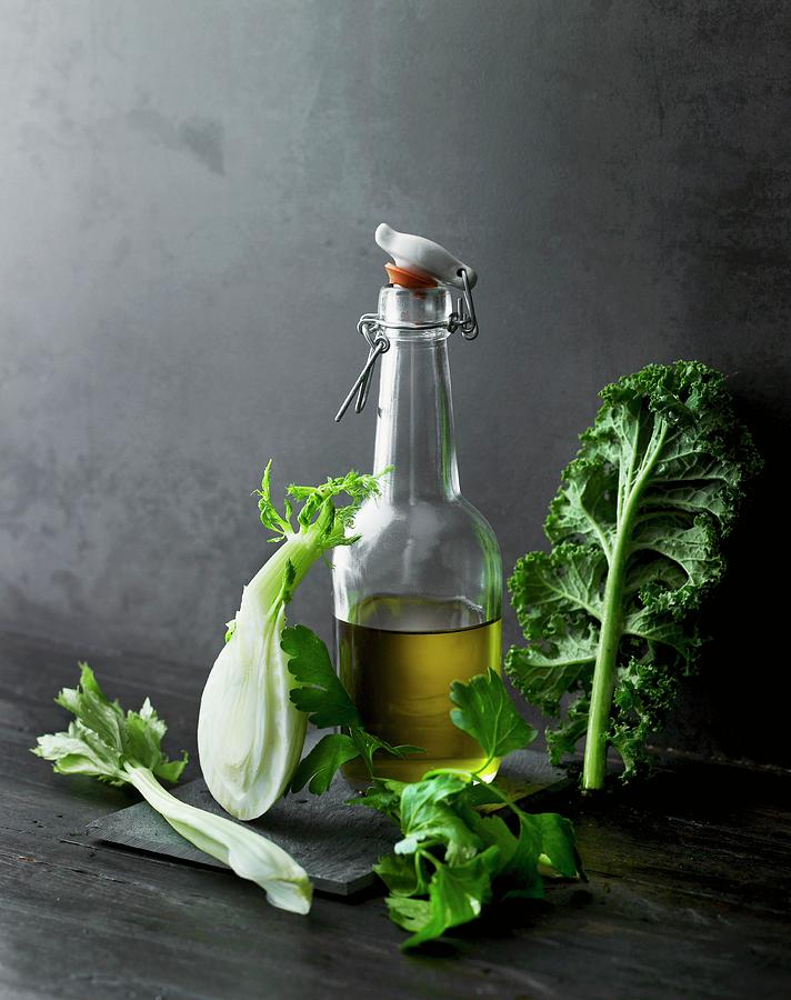 An Arrangement Of Olive Oil, Vegetables And Herbs Photograph by Lars Ranek
