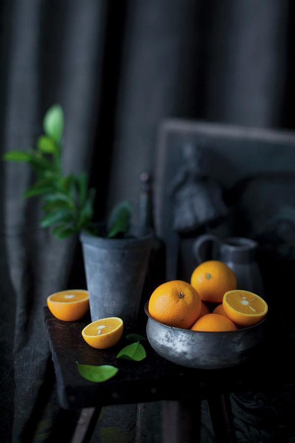 An Arrangement Of Oranges In A Bowl And On A Stool Photograph by Grossmann.schuerle Jalag
