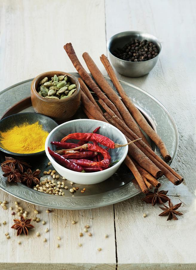 An Arrangement Of Spices Featuring Cinnamon, Cardamom, Chillis, Star Anise, Pepper, Coriander And Turmeric Photograph by Victoria Firmston