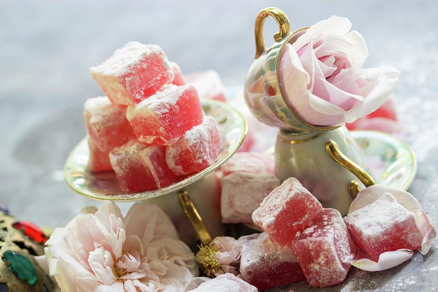 An Arrangement Of Turkish Rose Jelly With Icing Sugar In Mocha Cups And Small Saucers With Roses In Between Photograph by Charlotte Von Elm