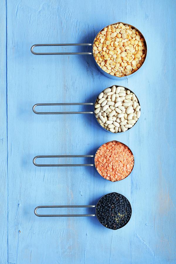 An Arrangement Of Yellow Peas, White Beans, Red And Black Lentils Photograph by Rua Castilho