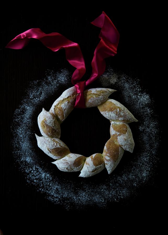 An Artisan Bread Wreath With A Red Satin Ribbon Photograph by Lisa Rees