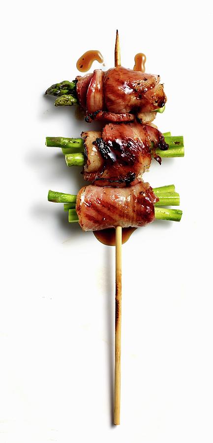 An Asparagus And Bacon Skewer With Black Pepper Teriyaki Sauce Photograph by Clinton Hussey