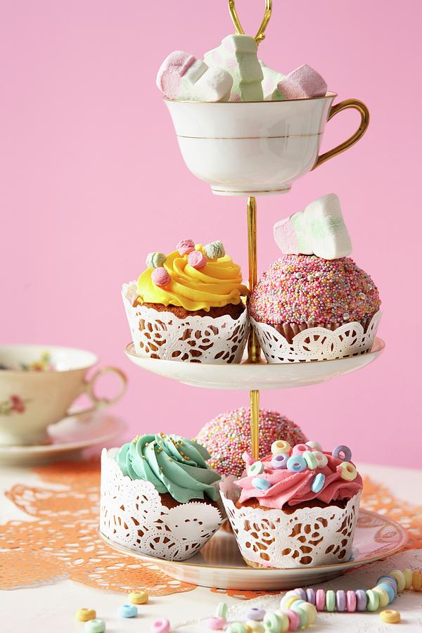 An Assortment Of Cupcakes And Marshmallows On A Tiered Cake Stand Photograph by Frhlich, Heidi
