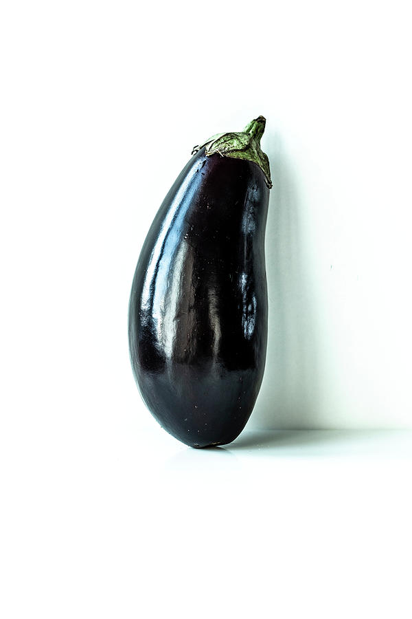 An Aubergine On A White Background Photograph by Simone Neufing