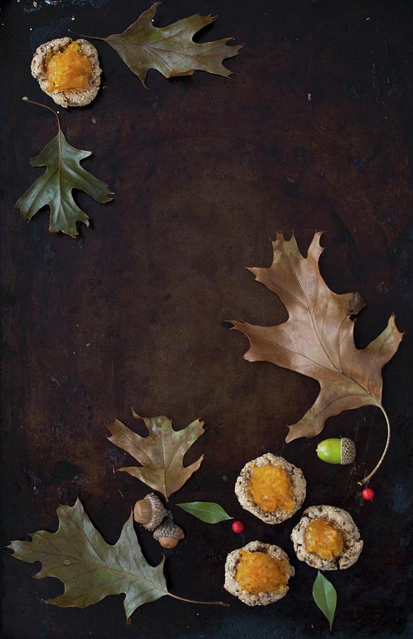 An Autumn Still Life With Leaves, Acorns And Amaranth Cookies Topped With Pumpkin Jam Photograph by Yelena Strokin