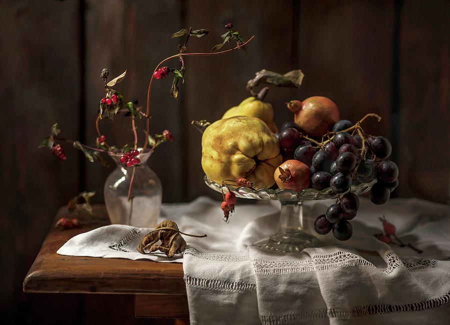 An Autumnal Arrangement Of Fruit Featuring Qunices, Grapes And Pomegranate Seeds Photograph by Piga & Catalano S.n.c.