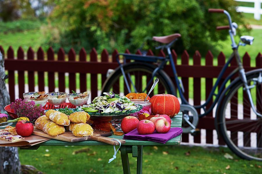 An Autumnal Buffet On A Wooden Table In A Garden Photograph by Hannah Kompanik