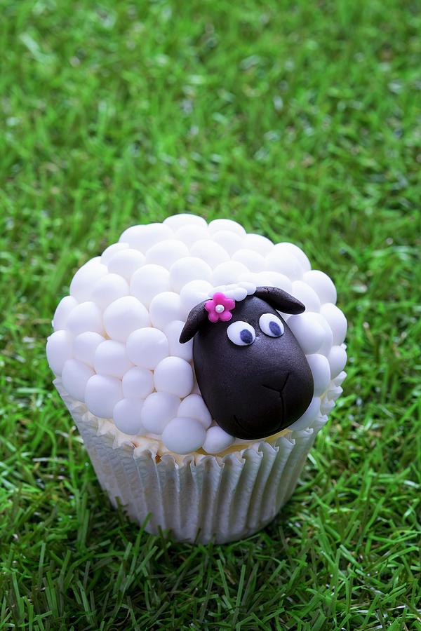 An Easter Lamb Cupcake On A Grass Surface Photograph by Adrian Britton