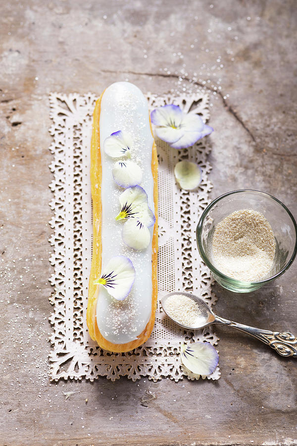 An Eclair With Champagne Cassis And Pansies Photograph by Eising Studio