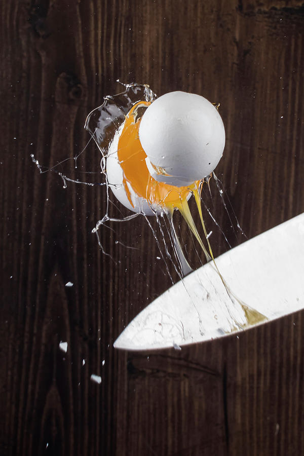 An Egg Cracked With A Knife Photograph by Derek Bissonnette