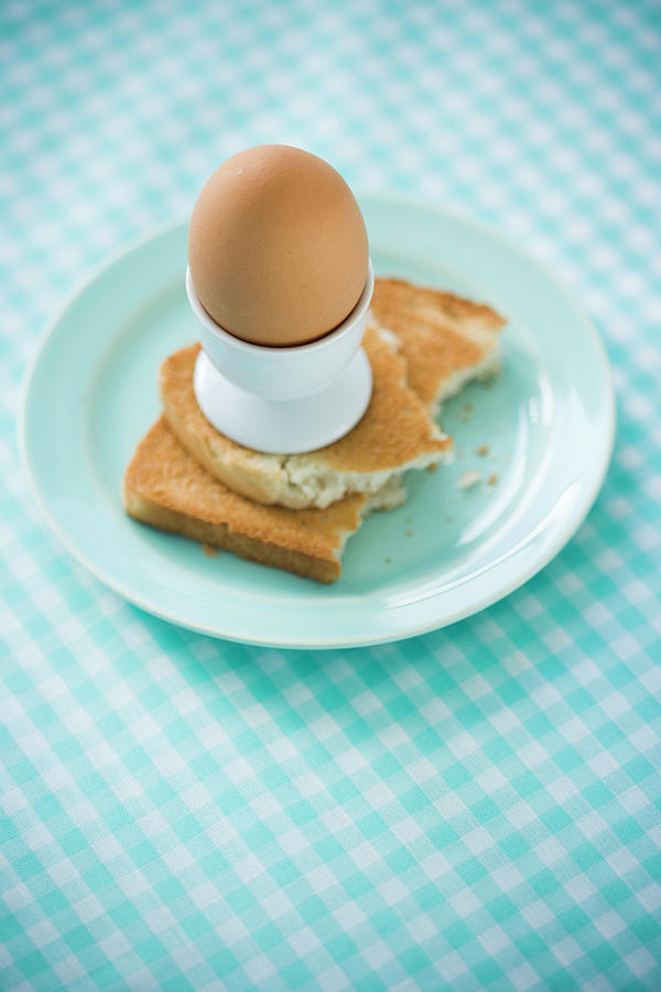 An Egg In A Eggcup On A Slice Of Toast Photograph by Colin Cooke