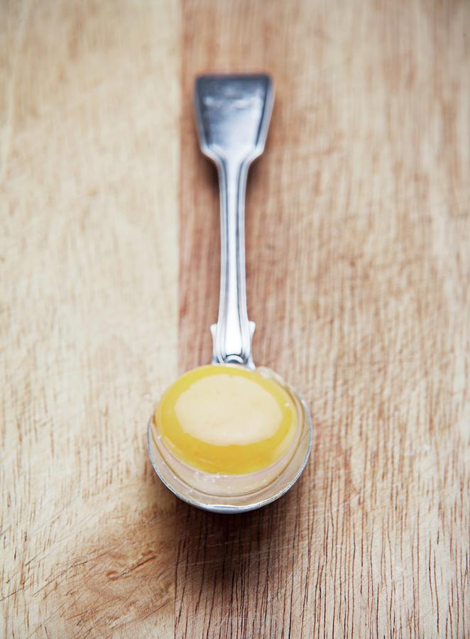 An Egg Yolk On A Spoon Photograph by Richard Church