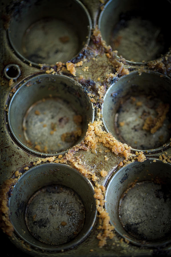 An Empty Muffin Tins With Cake Crumbs Photograph by Eising Studio