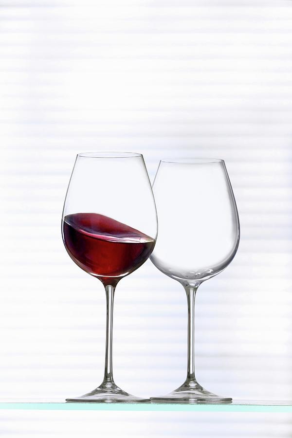 An Empty Wine Glass And A Glass Of Red Wine Photograph by Jalag / Michael Bernhardi