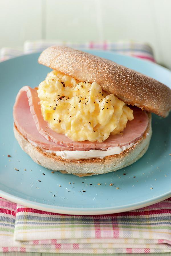 An English Muffin Topped With Scrambled Eggs And Ham Photograph by Jonathan Short