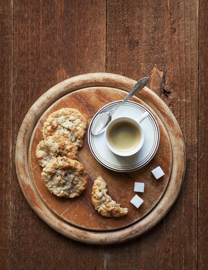 An Espresso With Cookies On A Round Wooden Board seen From Above Photograph by George Crudo