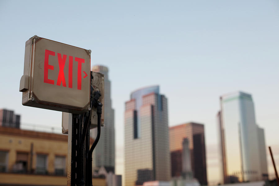 An Exit Sign In Fron Of A Big City Photograph by Frank Rothe