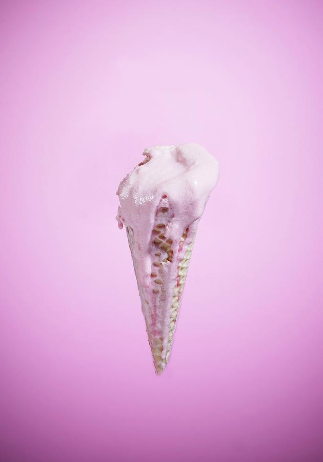 An Ice Cream Cone With Melting Strawberry Ice Cream Photograph by Osborne, Ria