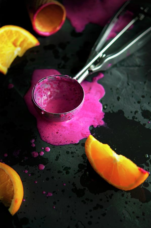 An Ice Cream Scoop With Melted Berry Sorbet And Oranges Photograph by Kristy Snell