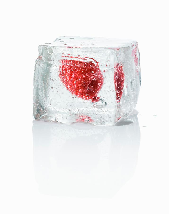 An Ice Cube With A Rapsberry Photograph by Krger & Gross