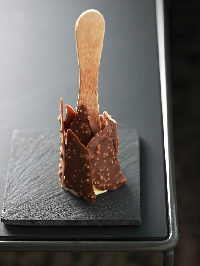 An Ice Lolly Coated With Chocolate And Chopped Nuts Photograph by Atelier Mai 98