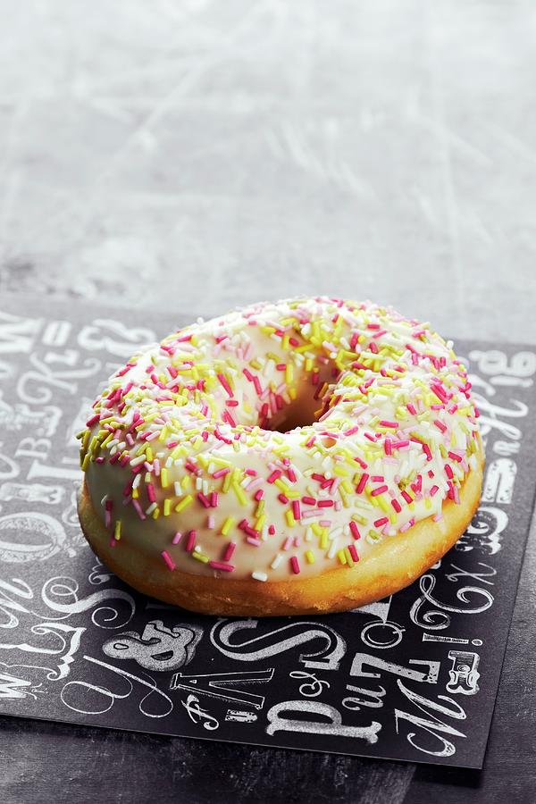An Iced Doughnut With Sugar Sprinkles Photograph by Miriam Rapado