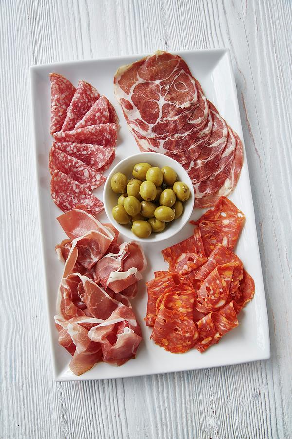 An Italian Antipasti Platter With Ham, Salami And Olives Photograph by Clive Streeter