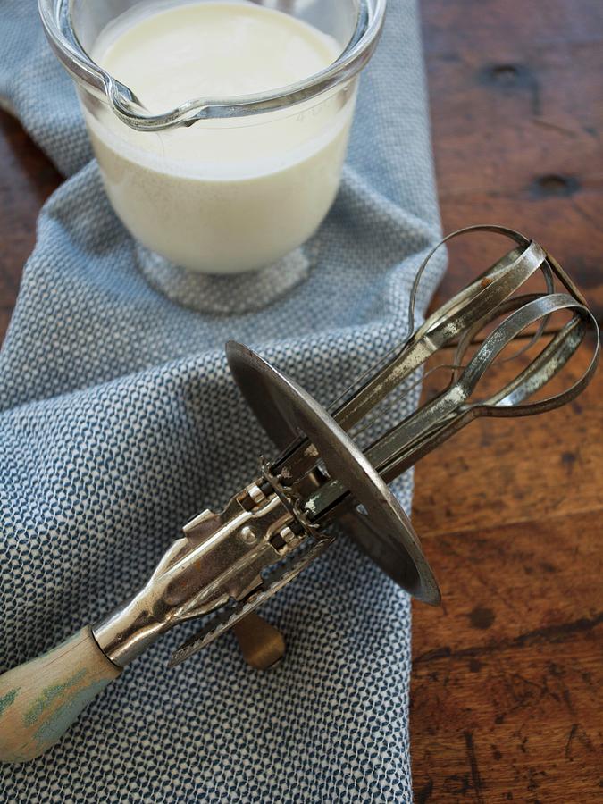 An Old Hand Mixer And Liquid Cream Photograph by Ryla Campbell