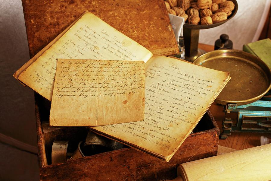 An Old, Handwritten Recipe Book With A Pair Of Scales And Walnuts Photograph by Herbert Lehmann