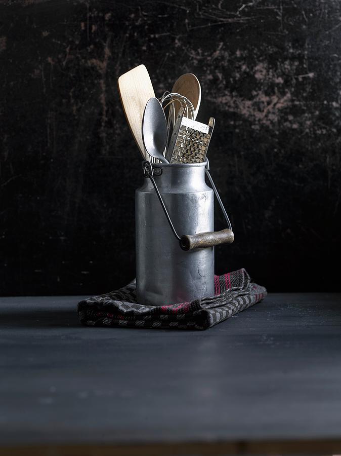 An Old Milk Jug With A Whisk, Wooden Spoon And Grater Photograph by Michael Ruder