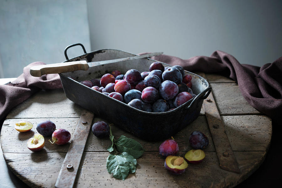 An Old Roasting Pan Full Of Fresh Plums Photograph by Kati Neudert