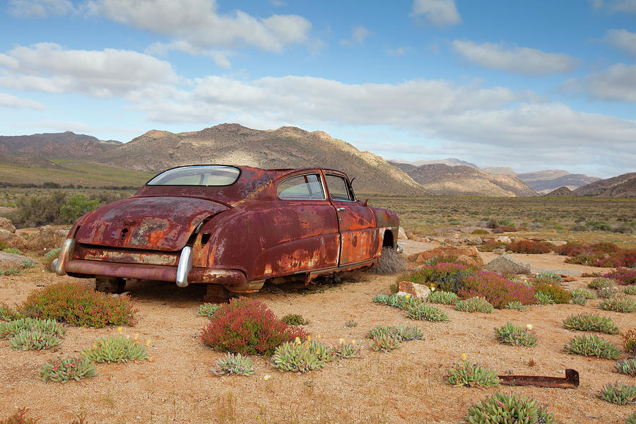 An Old Rusted Car Lies Derelict In Photograph by Anthony Grote