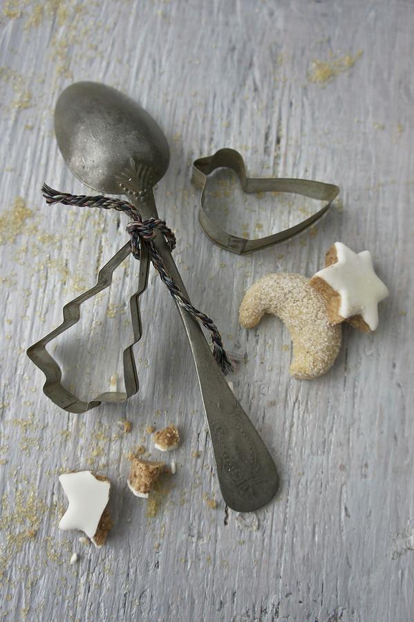 An Old Spoon, Cookie Cutters, Vanilla Biscuits And Cinnamon Stars Photograph by Martina Schindler