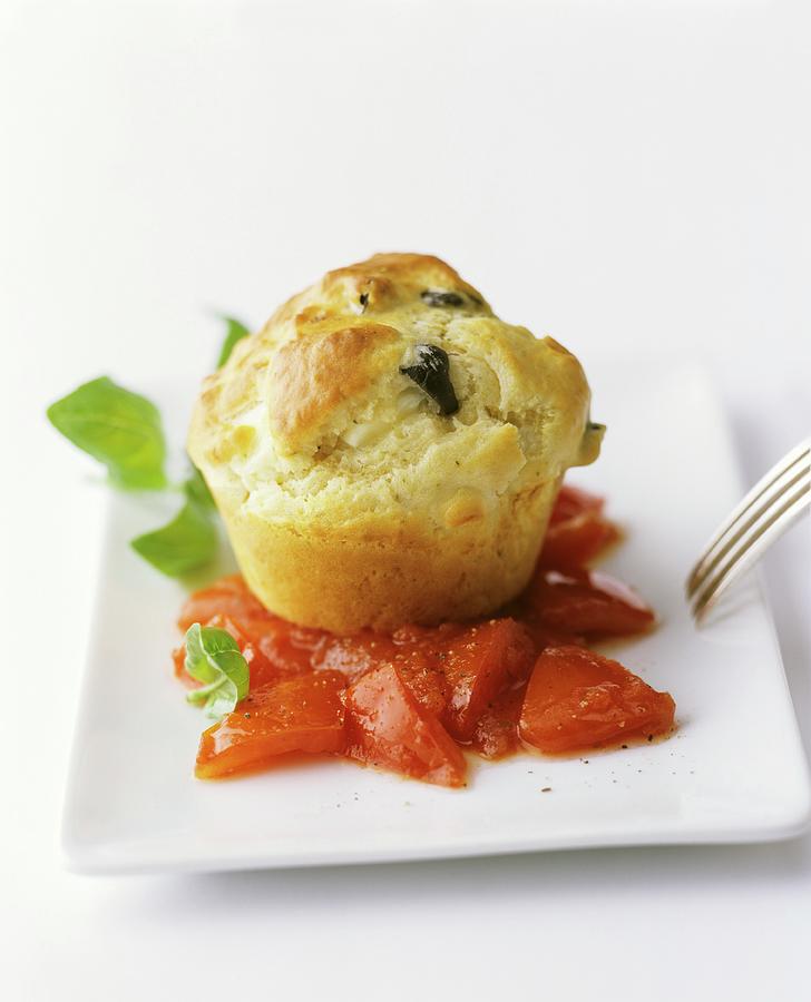An Olive Muffin On Tomatoes With Basil Photograph by Michael Wissing