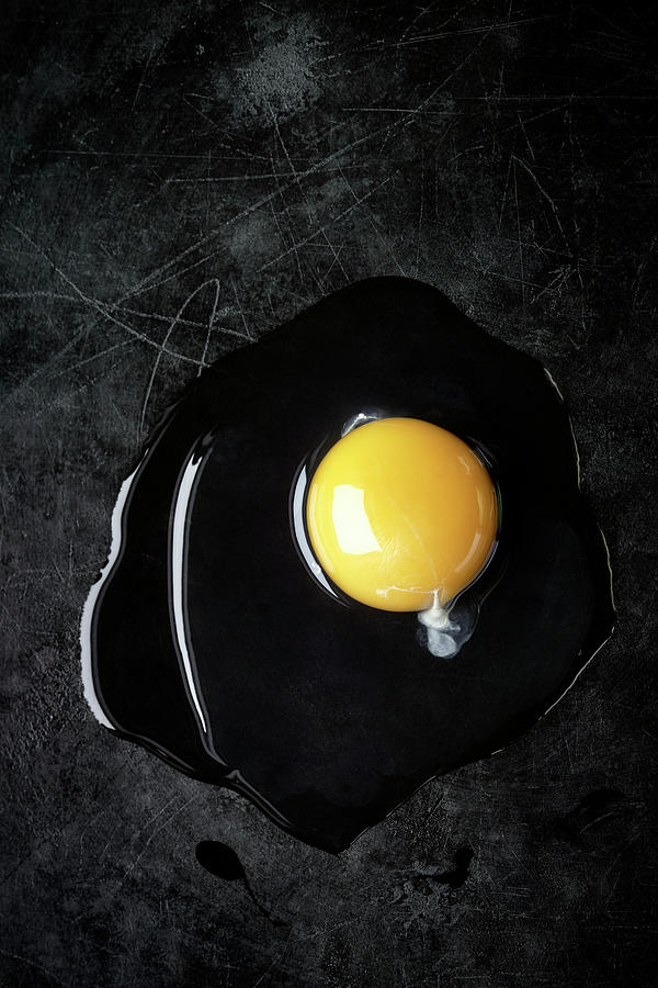 An Open Egg On A Black Metal Background Photograph by Manfred Rave