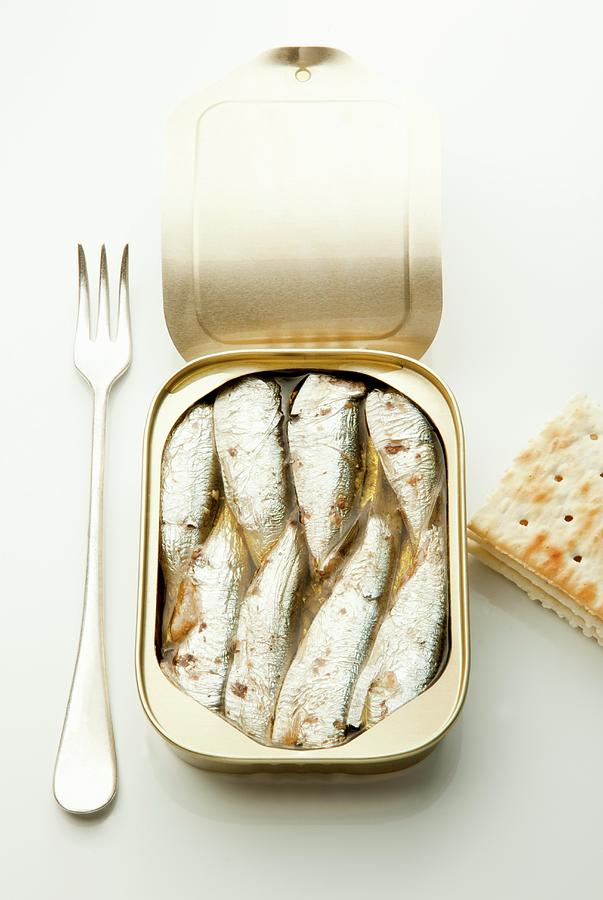 An Open Tin Of Sardines With A Fork And Crackers Photograph by William