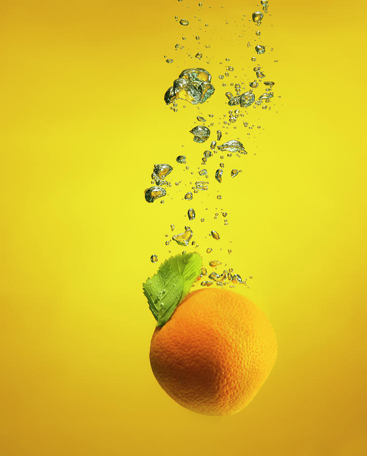 Fruit Photograph - An Orange Splashed Into Water by Henrik Sorensen