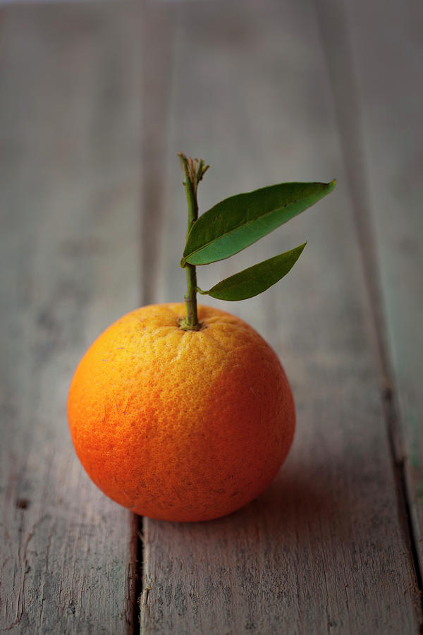 An Orange With A Leaf Photograph by Adolforuizmaeso