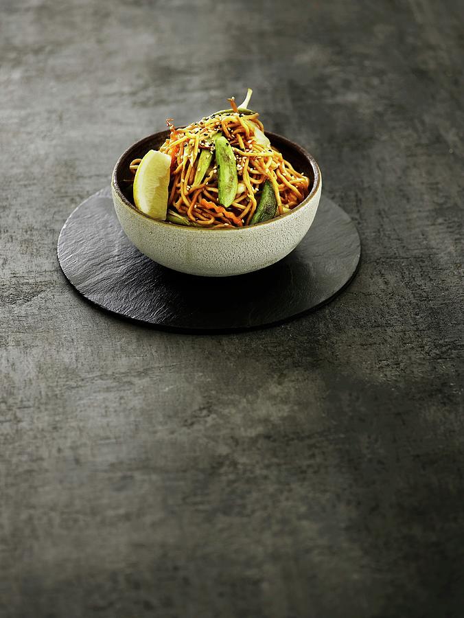 An Oriental Vegetable Dish With Fried Noodles And Lemon Photograph by Mikkel Adsbl