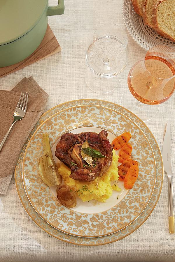 And Elegant Place Setting With Veal Knuckle In Wine And Lemons On Polenta, Main Course Photograph by Jalag / Olaf Szczepaniak