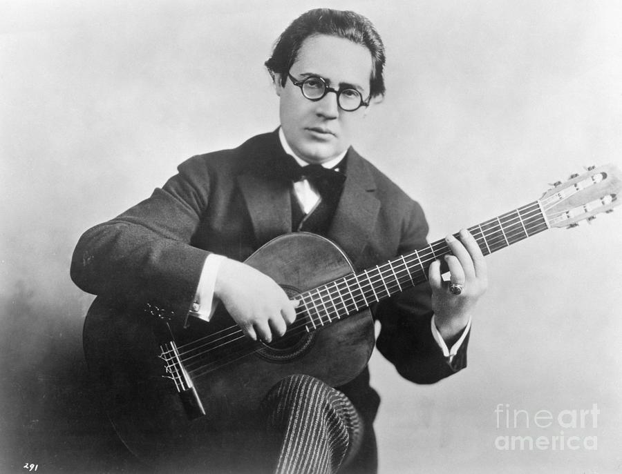 Andres Segovia Seated Holding Guitar Photograph by Bettmann