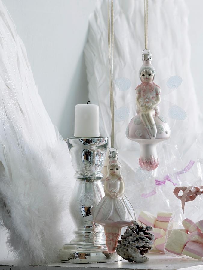 Angel Christmas Tree Baubles Next To Chrome Candlestick In Front Of Decorative Angels Wings Leaning On Wall Photograph by Matteo Manduzio