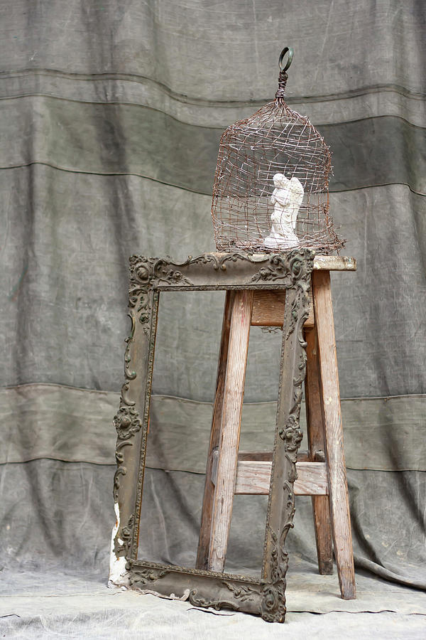 Angel Figurine In Cage On Wooden Stool And Antique Picture Frame Photograph by Alicja Koll