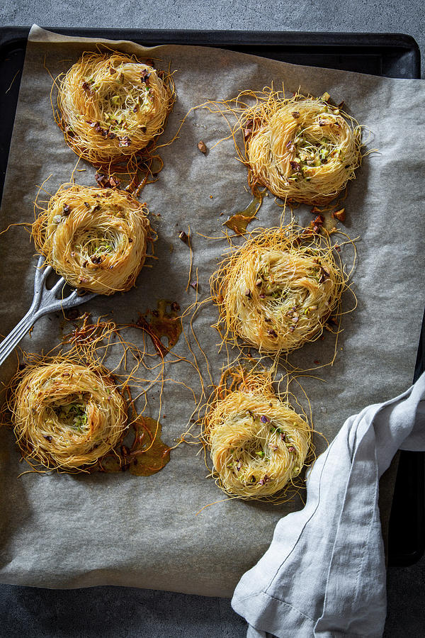 Angel Hair Pasta Nests With Pistachios On A Baking Tray With Baking Paper And A Vintage Spatula Photograph by Food With A View