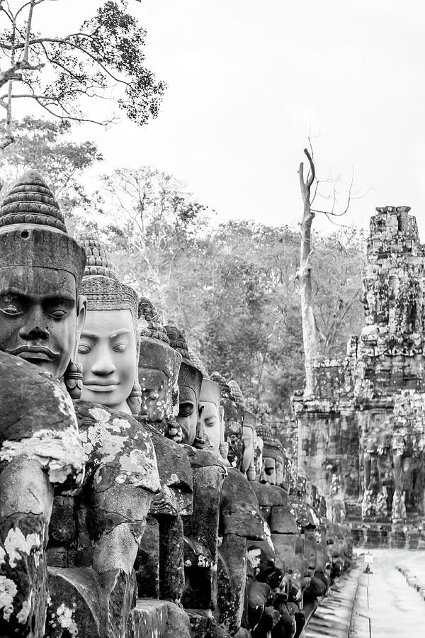 Angels on bridge of South Gate in Angkor Thom in black and white Photograph by Karen Foley