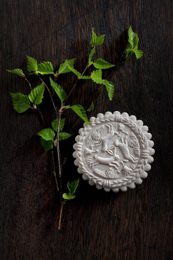 Aniseed Biscuit With Moulded Hare Motif And Young Birch Twig On Wooden Table Photograph by Sabine Lscher
