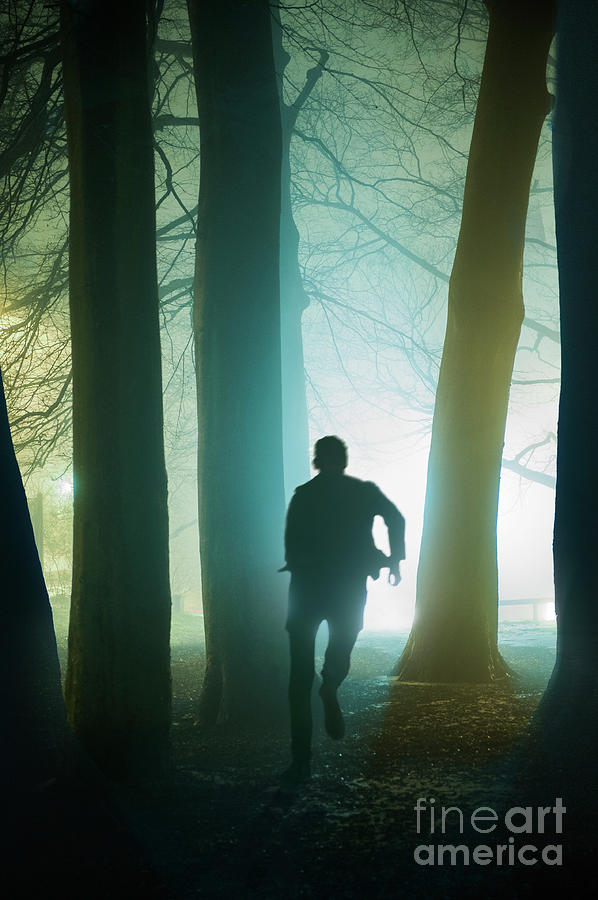 Anonymous Man In Silhouette Running Through Foggy Winter Forest Photograph By Lee Avison