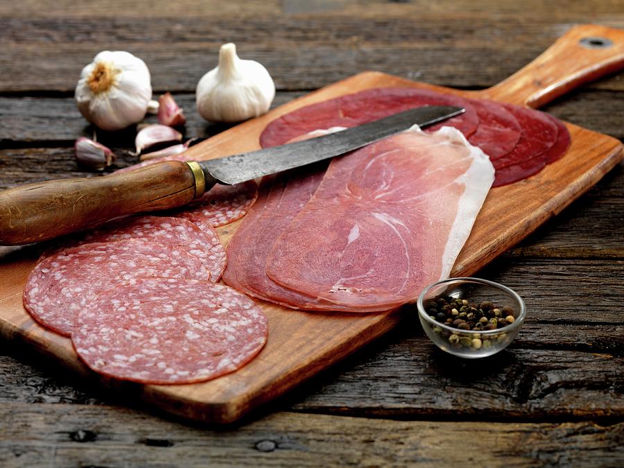 Antipasti On A Wooden Board: Salami, Parma Ham, Bresaola Photograph by Robert Morris